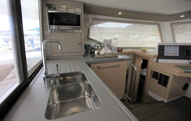 La Mer Kat Yacht Photos Pics Modern kitchen interior of 2016 Fountaine Pajot Lucia 40 catamaran with stainless steel sink.