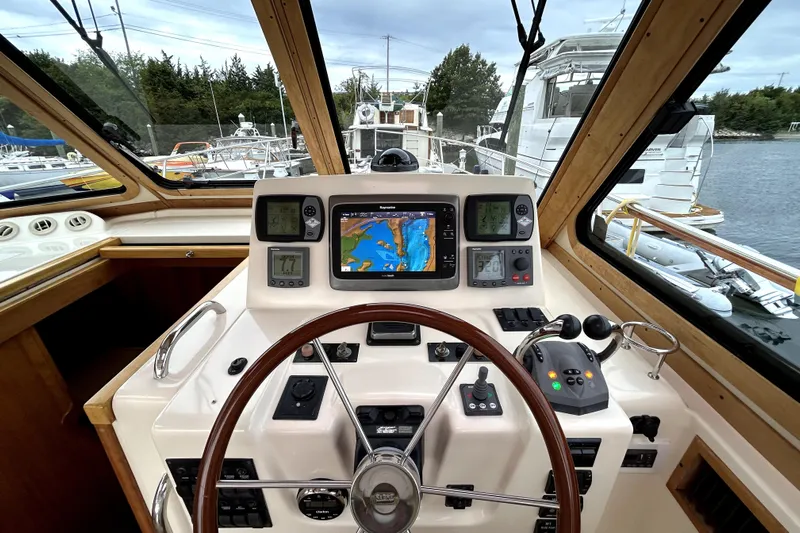  Yacht Photos Pics 2006 Sabre 38 Hard Top Express helm with navigation equipment and steering wheel.