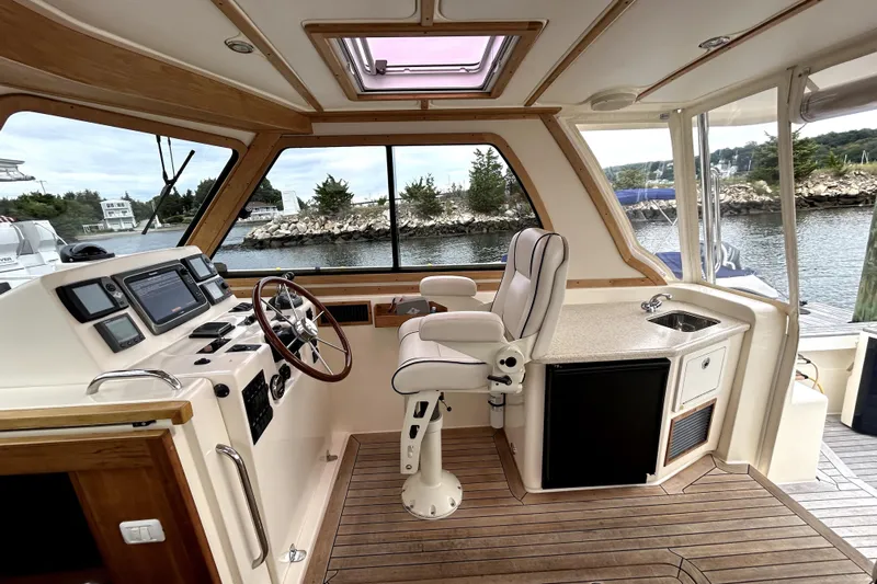  Yacht Photos Pics Interior of 2006 Sabre 38 Hard Top Express yacht with helm, seating, and kitchenette.