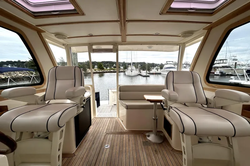  Yacht Photos Pics Interior of 2006 Sabre 38 Hard Top Express yacht with luxurious seating and scenic marina view.