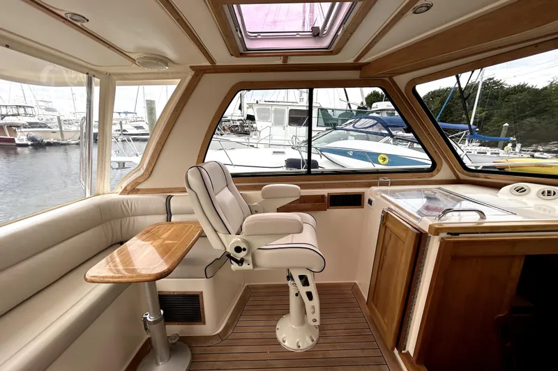  Yacht Photos Pics Interior of 2006 Sabre 38 Hard Top Express yacht with helm seat and wooden accents.