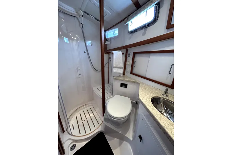  Yacht Photos Pics Bathroom interior of 2006 Sabre 38 Hard Top Express yacht, featuring shower, toilet, and sink.