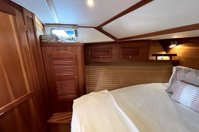  Yacht Photos Pics Cozy cabin interior of 2006 Sabre 38 Hard Top Express with wooden finishes and bedding.