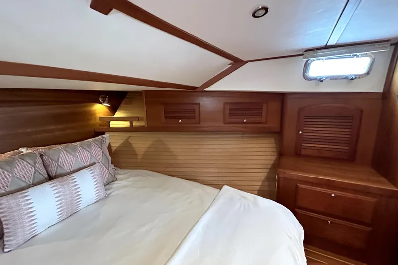  Yacht Photos Pics Cozy cabin interior of 2006 Sabre 38 Hard Top Express with wooden finish and bedding.