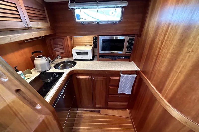  Yacht Photos Pics 2006 Sabre 38 Hard Top Express galley with wood cabinetry, sink, and appliances.