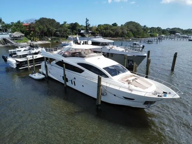  Yacht Photos Pics Astondoa 96 GLX 2009 yacht docked in a marina, surrounded by water and other boats.