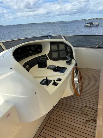  Yacht Photos Pics Control deck of 2009 Astondoa 96 GLX yacht with wooden steering wheel and navigation instruments.