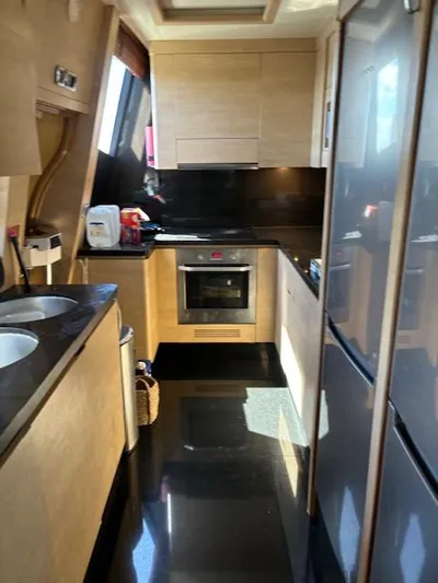  Yacht Photos Pics Modern kitchen interior on a 2009 Astondoa 96 GLX yacht, featuring sleek cabinetry and appliances.