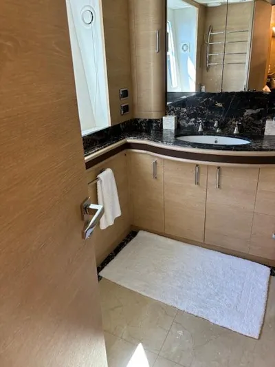  Yacht Photos Pics Luxurious bathroom in 2009 Astondoa 96 GLX yacht with modern fixtures and wood cabinetry.