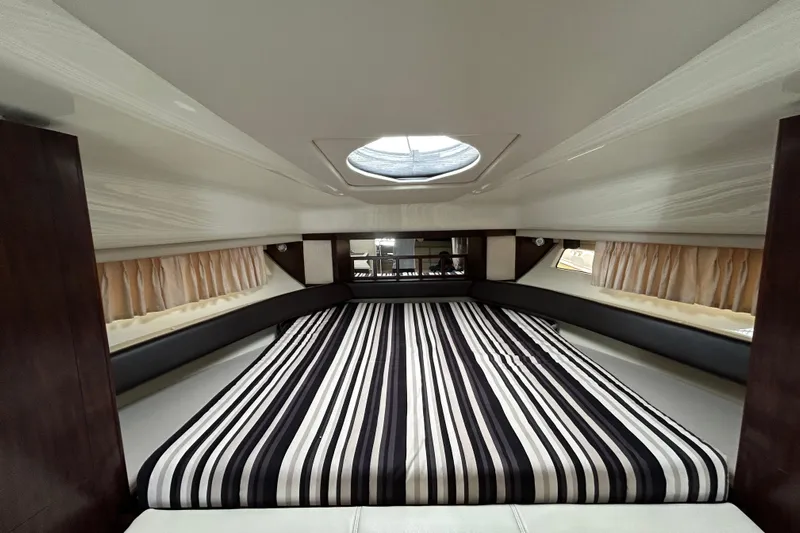  Yacht Photos Pics Interior cabin of 2017 Monterey 355 Sport Yacht with striped bedding and skylight.