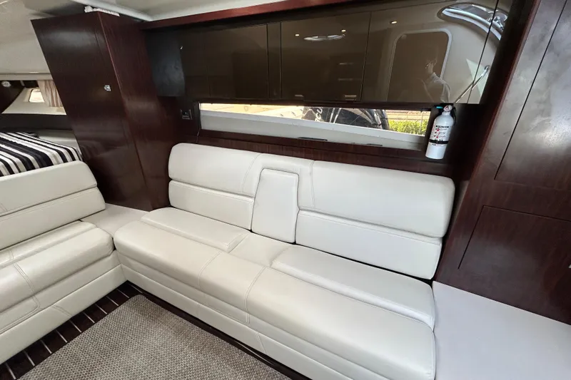  Yacht Photos Pics Luxurious interior of 2017 Monterey 355 Sport Yacht with white leather seating and wood accents.