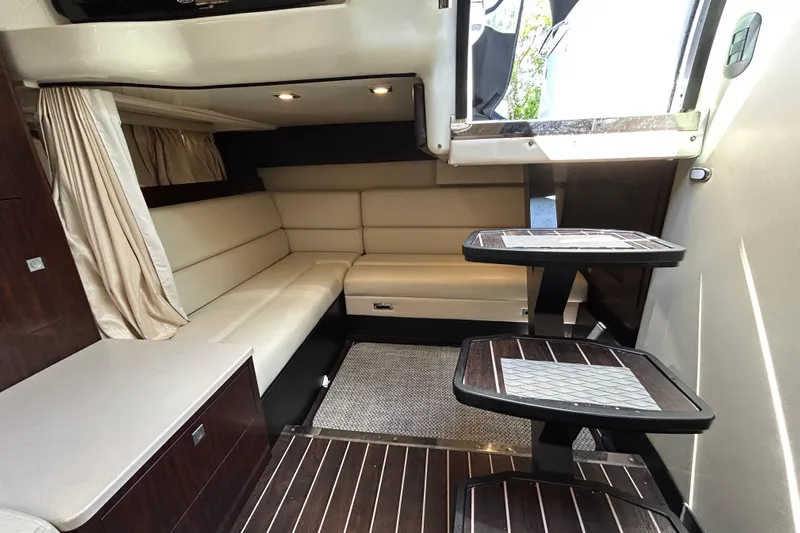  Yacht Photos Pics 2017 Monterey 355 Sport Yacht interior with beige seating and wooden accents.