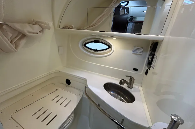  Yacht Photos Pics 2017 Monterey 355 Sport Yacht bathroom with sink, mirror, and porthole window.