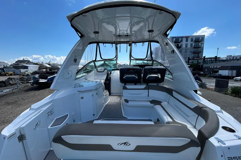  Yacht Photos Pics 2017 Monterey 355 Sport Yacht interior with seating, docked under clear blue sky.