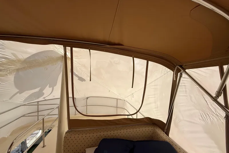  Yacht Photos Pics Interior view of 2006 Mainship 34 Trawler with beige canopy and railing.