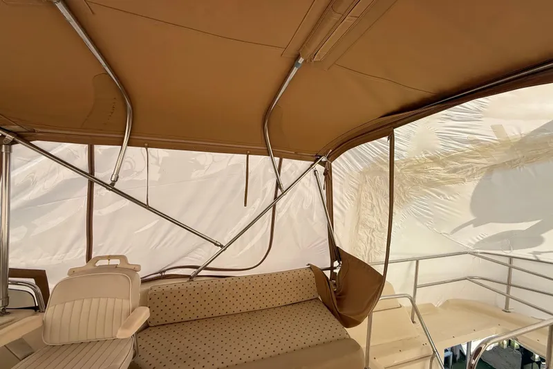  Yacht Photos Pics 2006 Mainship 34 Trawler interior with beige seating and canopy.