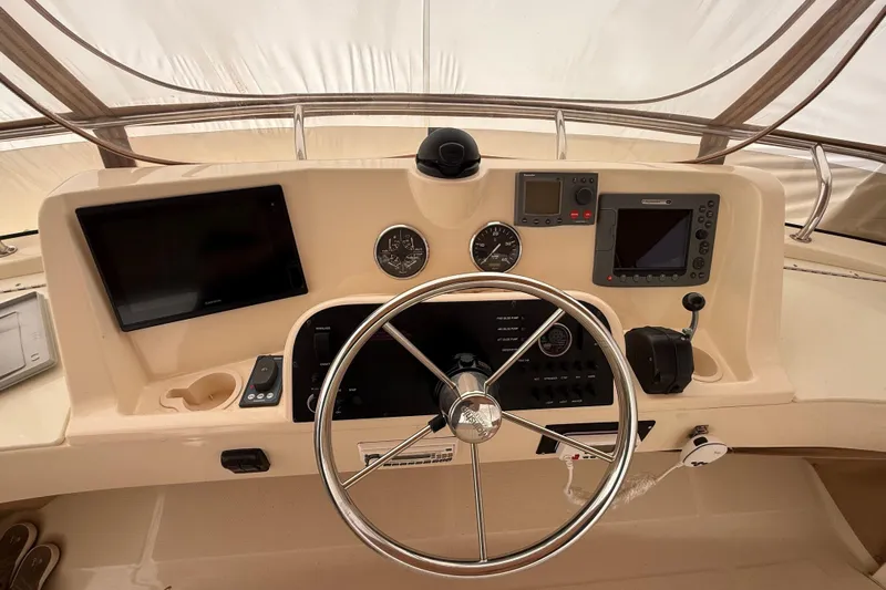  Yacht Photos Pics 2006 Mainship 34 Trawler helm with steering wheel, gauges, and navigation equipment.