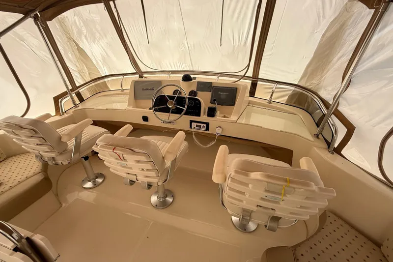  Yacht Photos Pics 2006 Mainship 34 Trawler helm with three seats and navigation equipment.