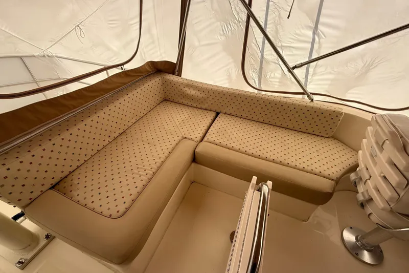 Yacht Photos Pics 2006 Mainship 34 Trawler interior with beige cushioned seating and protective canopy.