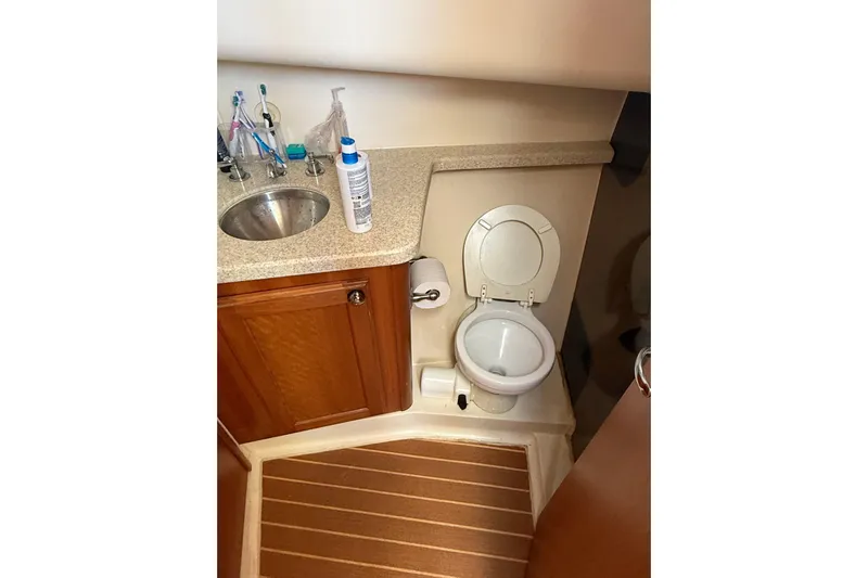  Yacht Photos Pics Bathroom interior of 2006 Mainship 34 Trawler with sink and toilet.