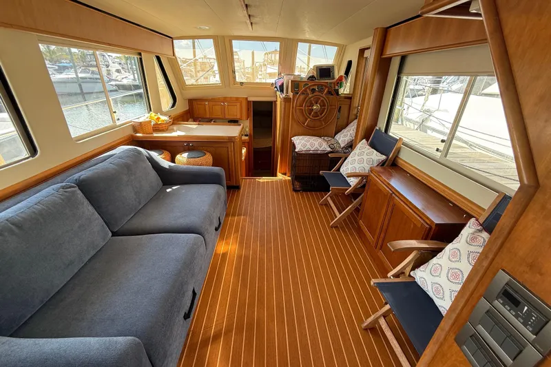  Yacht Photos Pics Interior of 2006 Mainship 34 Trawler with cozy seating and wooden accents.