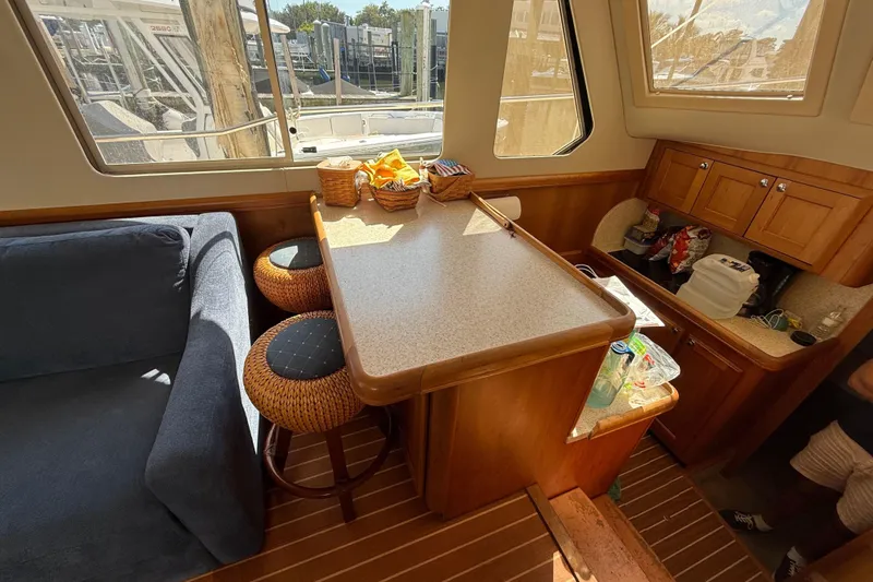  Yacht Photos Pics Interior of 2006 Mainship 34 Trawler with dining area and kitchen amenities.