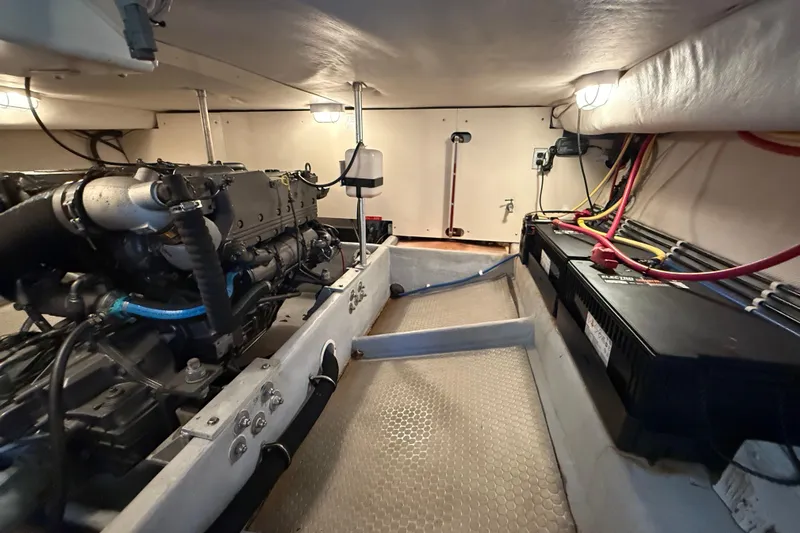  Yacht Photos Pics Engine room of 2006 Mainship 34 Trawler with visible engine and battery setup.