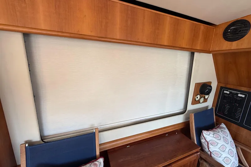  Yacht Photos Pics Interior of 2006 Mainship 34 Trawler with wood paneling and nautical instruments.