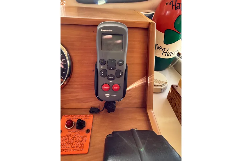  Yacht Photos Pics Remote control on Mainship 34 Trawler 2006 dashboard with warning label and decor.