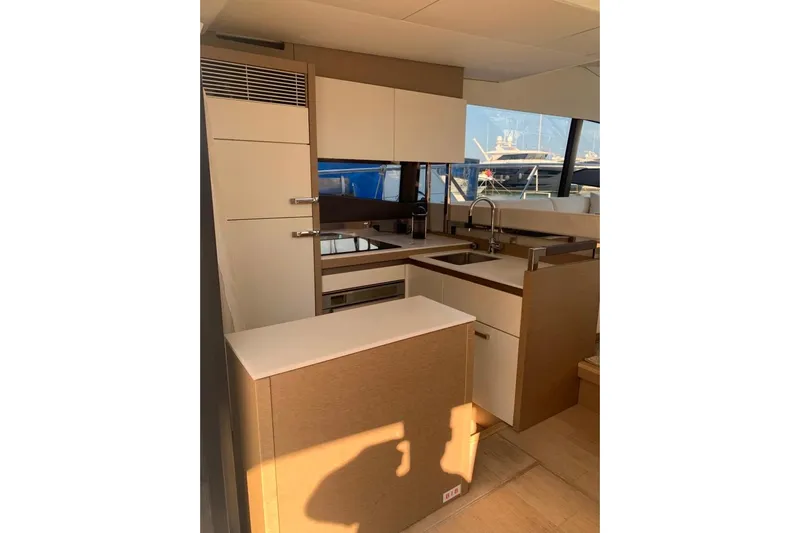 Fly Away Yacht Photos Pics Modern kitchen interior on a 2018 Prestige 520 yacht, featuring sleek cabinetry and appliances.