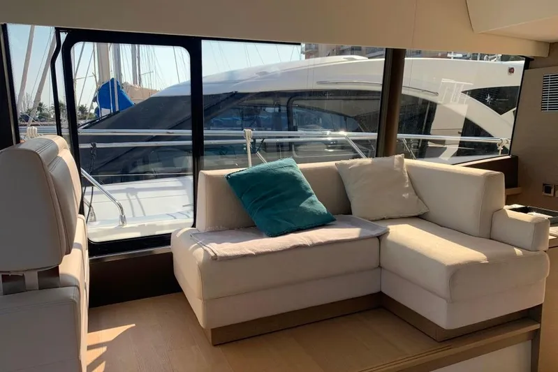 Fly Away Yacht Photos Pics Luxurious interior of 2018 Prestige 520 yacht with comfortable seating and large windows.
