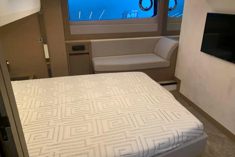 Fly Away Yacht Photos Pics Luxurious cabin interior of 2018 Prestige 520 yacht with bed, sofa, and window view.