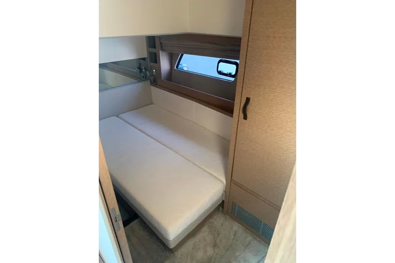 Fly Away Yacht Photos Pics Compact cabin interior of 2018 Prestige 520 yacht with bed and window.