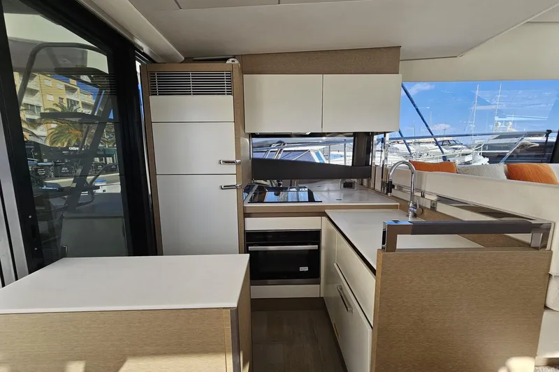 Fly Away Yacht Photos Pics Modern kitchen interior on 2018 Prestige 520 yacht, featuring sleek cabinetry and appliances.