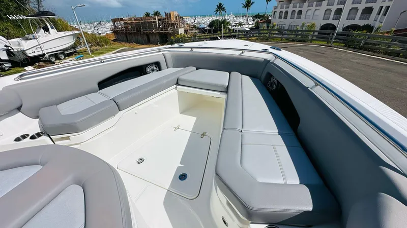  Yacht Photos Pics 2023 Boston Whaler 360 Outrage boat interior with spacious seating and modern design.
