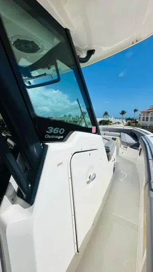  Yacht Photos Pics 2023 Boston Whaler 360 Outrage boat, sleek design, sunny day, clear blue sky.