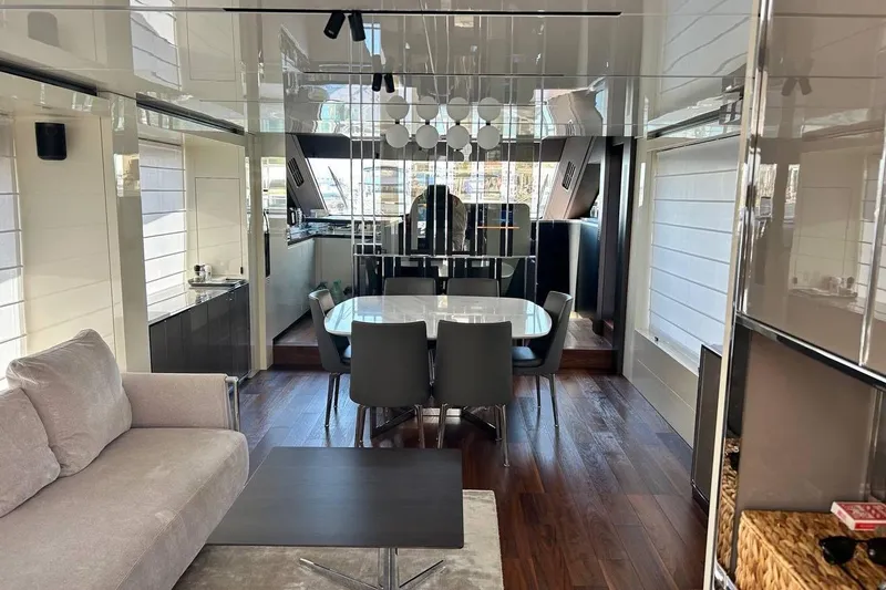  Yacht Photos Pics Luxurious interior of 2023 Cranchi Sessantasette 67 yacht with modern dining area and sleek design.
