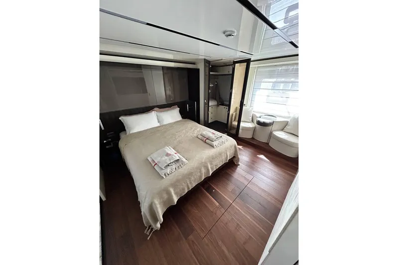 Yacht Photos Pics Luxurious bedroom interior of 2023 Cranchi Sessantasette 67 yacht with elegant furnishings.