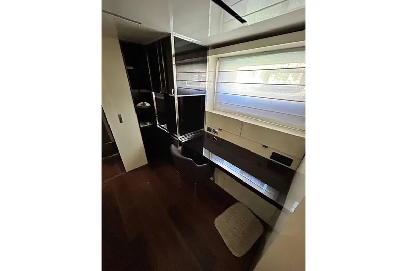 Yacht Photos Pics Luxurious interior of 2023 Cranchi Sessantasette 67 yacht with modern furnishings and window view.