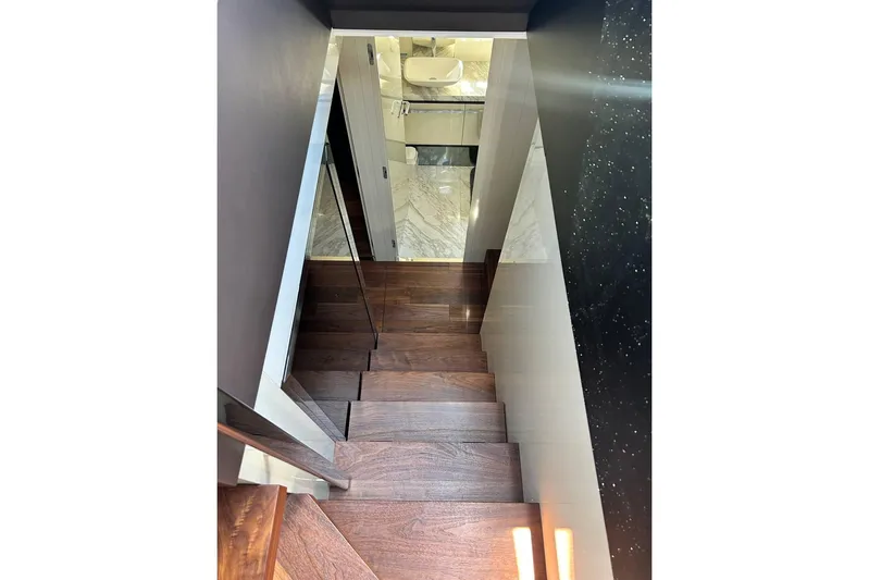  Yacht Photos Pics Staircase inside 2023 Cranchi Sessantasette 67 yacht with wooden steps and modern design.