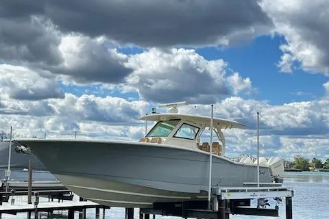 Seas Today Yacht Photos Pics 2019 Scout 355 LXF boat docked under cloudy sky.