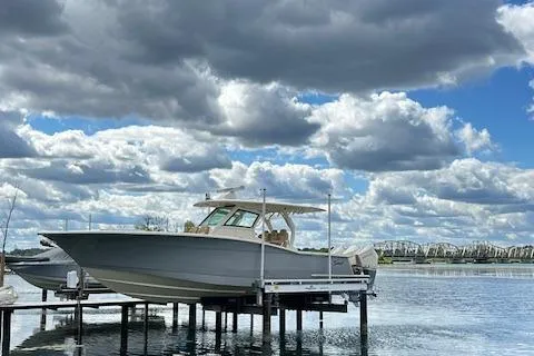 Seas Today Yacht Photos Pics 2019 Scout 355 LXF boat docked under cloudy sky.