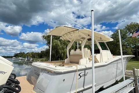 Seas Today Yacht Photos Pics 2019 Scout 355 LXF boat docked under a partly cloudy sky.