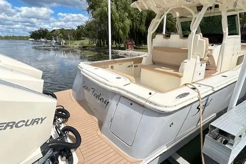 Seas Today Yacht Photos Pics 2019 Scout 355 LXF boat docked, featuring Mercury engines and spacious seating.