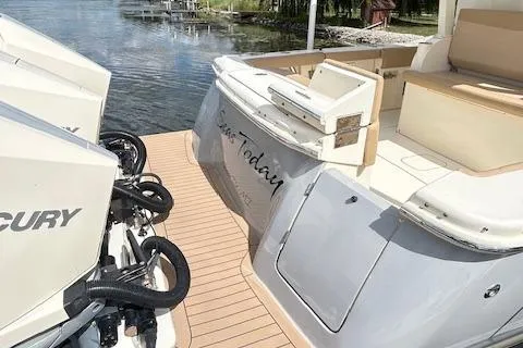 Seas Today Yacht Photos Pics 2019 Scout 355 LXF boat with Mercury engines, docked on a sunny day.
