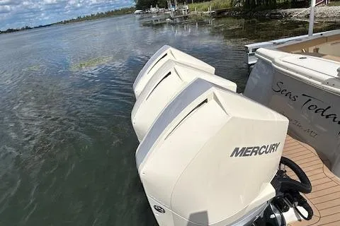 Seas Today Yacht Photos Pics 2019 Scout 355 LXF boat with triple Mercury outboard engines on a calm lake.