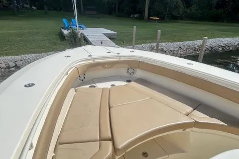 Seas Today Yacht Photos Pics 2019 Scout 355 LXF boat with tan seating, docked near a grassy area.