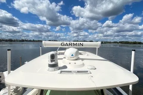 Seas Today Yacht Photos Pics 2019 Scout 355 LXF boat with Garmin equipment on a calm lake under a cloudy sky.