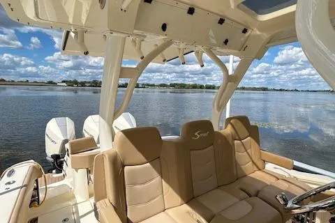 Seas Today Yacht Photos Pics 2019 Scout 355 LXF boat interior with tan seating, lake view, and twin engines.