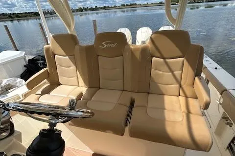 Seas Today Yacht Photos Pics 2019 Scout 355 LXF boat with tan leather seating, steering wheel, and water view.